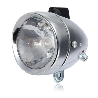 Silver dynamo-powered bicycle light set with generator unit for friction drive on wheel.