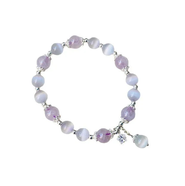 Moon-shaped women's bracelet with large opal amethyst crystal beads on wrist.