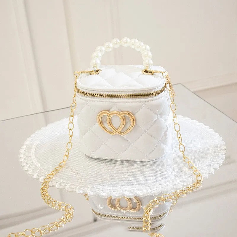 White PVC women's bucket bag with a heart-shaped pattern and shoulder strap.