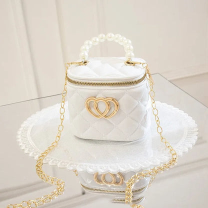 White PVC women's bucket bag with a heart-shaped pattern and shoulder strap.