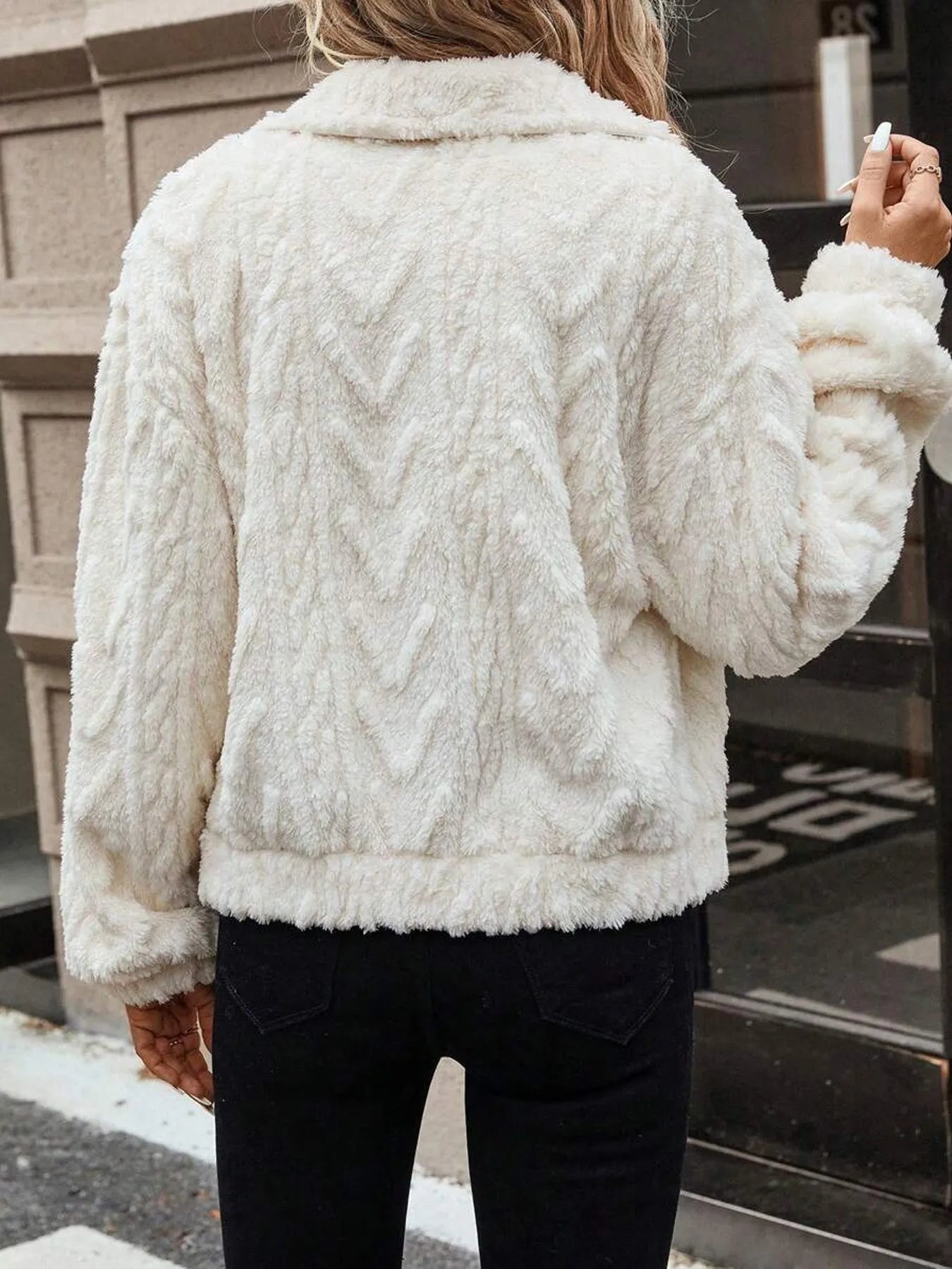 Ivory white women's button-front plush cardigan coat on a hanger
