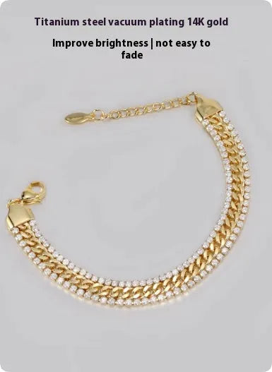 Gold-coloured titanium steel tennis bracelet with artificial gemstone inlay on a wrist.