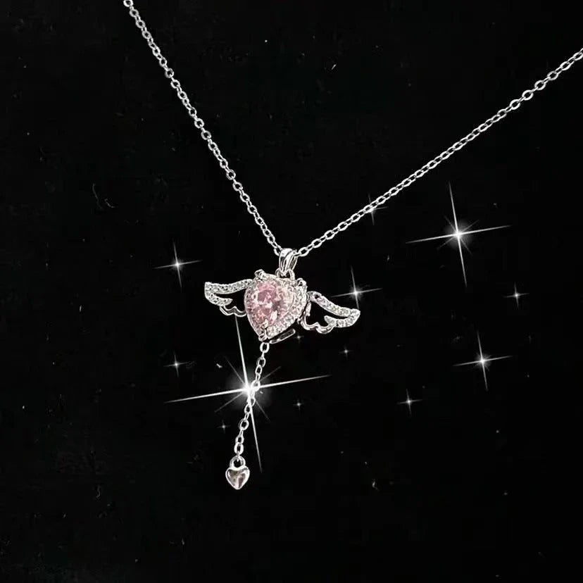 Elegant angel wings necklace with moving heart pendant, made of titanium steel and crystal accents