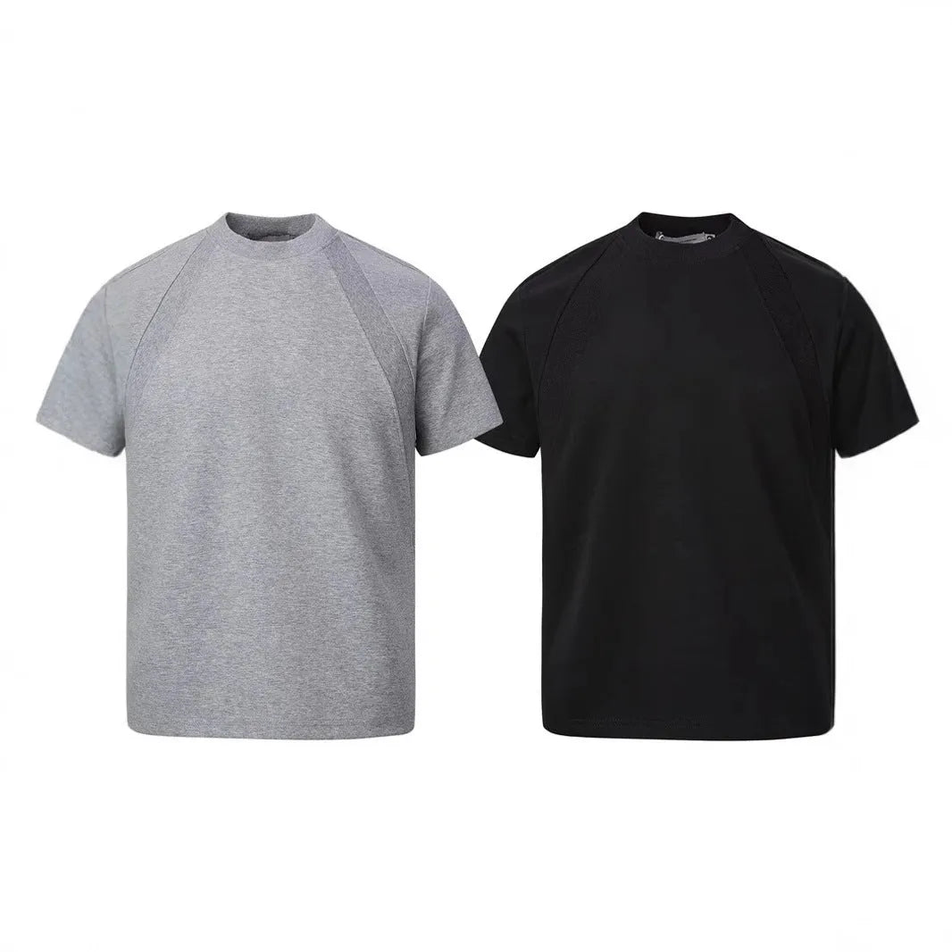 Loose-fit black short sleeve top with textured air layer stitching on a mannequin.