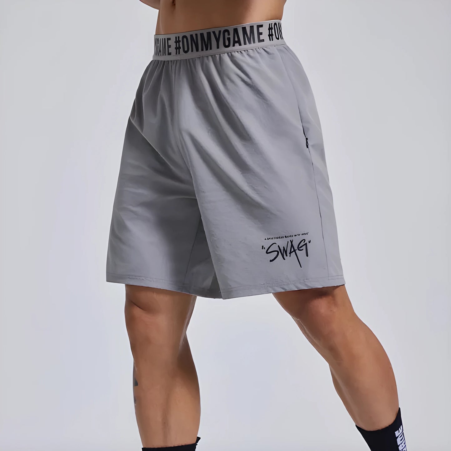 Men's loose black sports shorts with elastic waist and letter detail, shown front and back.