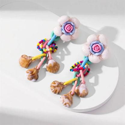 Handmade bohemian shell tassel earrings for women with colourful flower and geometric drop design