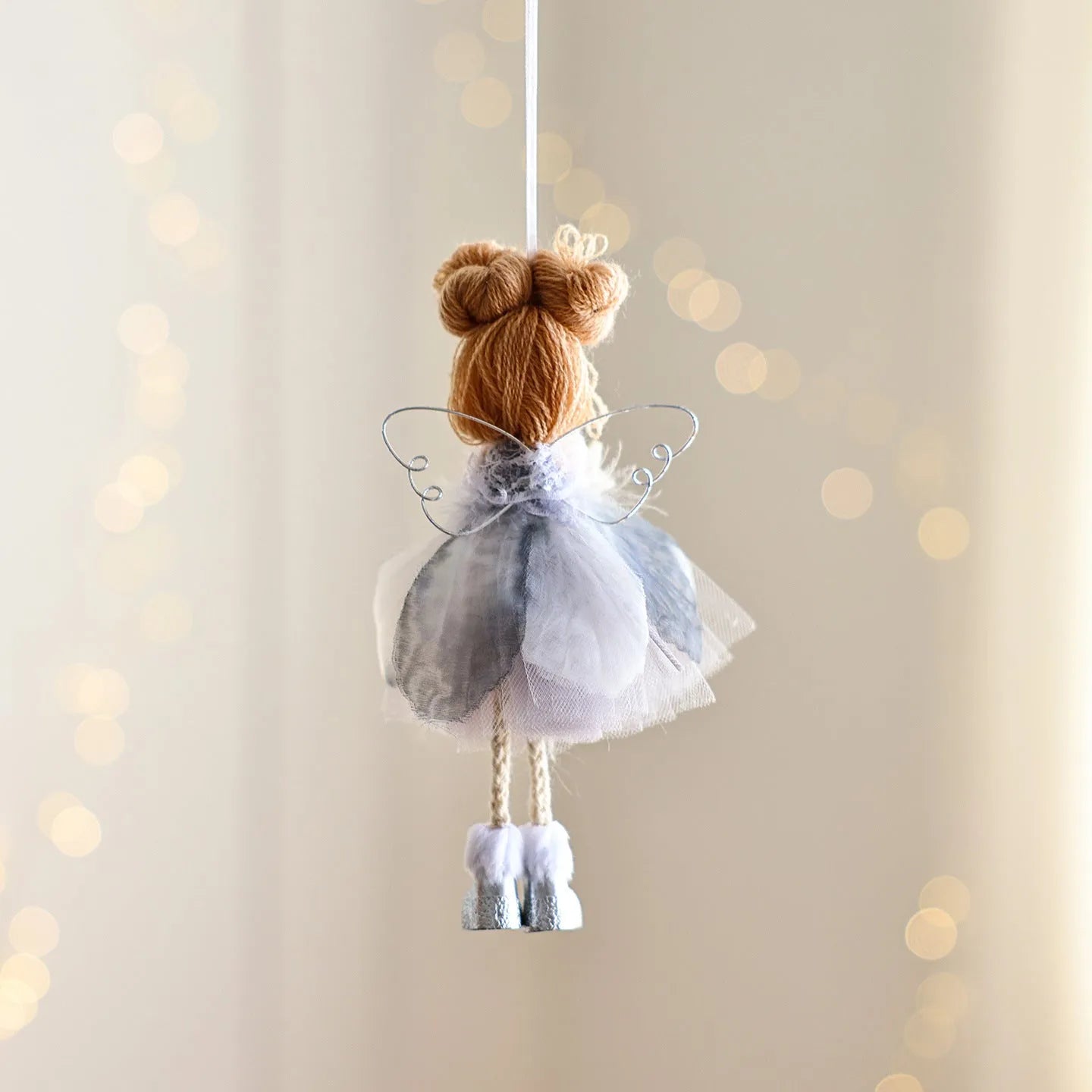White mesh angel girl Christmas ornament with snowflake detail hanging demonstration