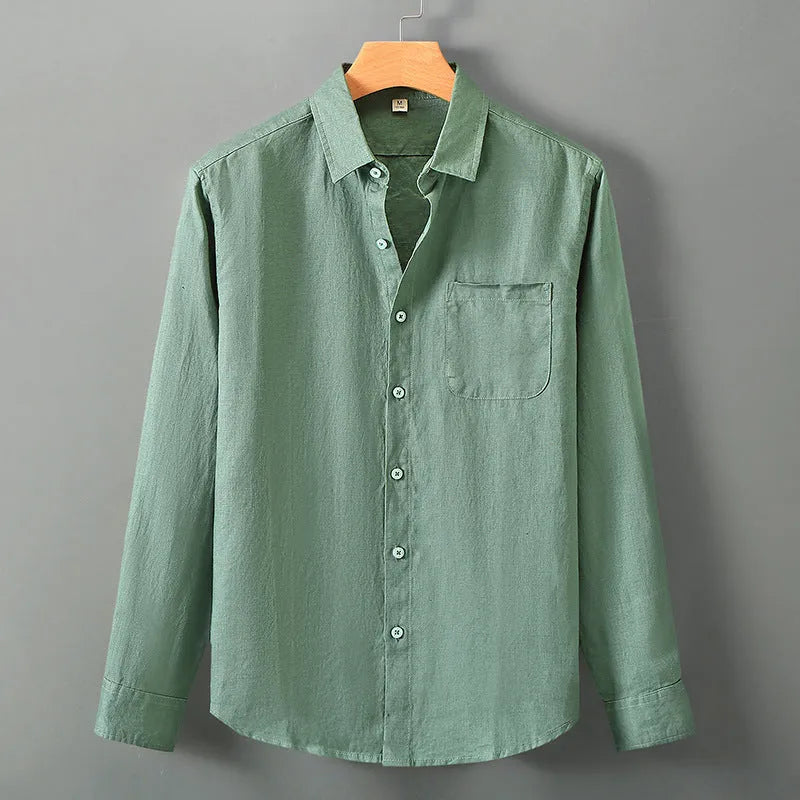 Man wearing a loose-fit light grey long sleeve linen cardigan shirt with a Chinese style design.