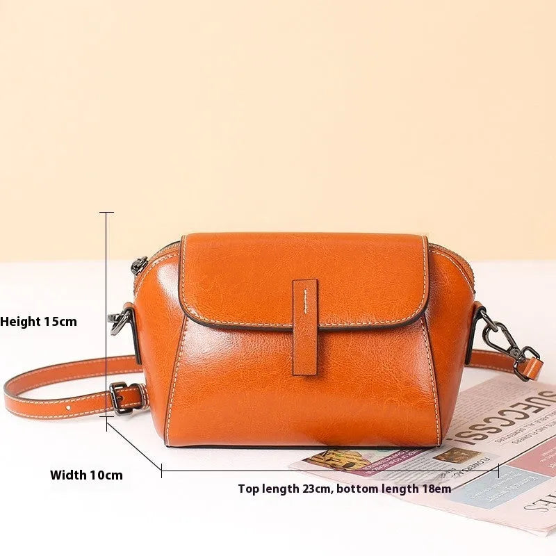 Women's brown oil wax cowhide leather messenger bag with crossbody strap and organised interior pockets