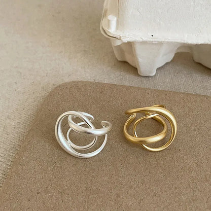 Three-dimensional interlaced geometric open ring in matte metal with real gold plating