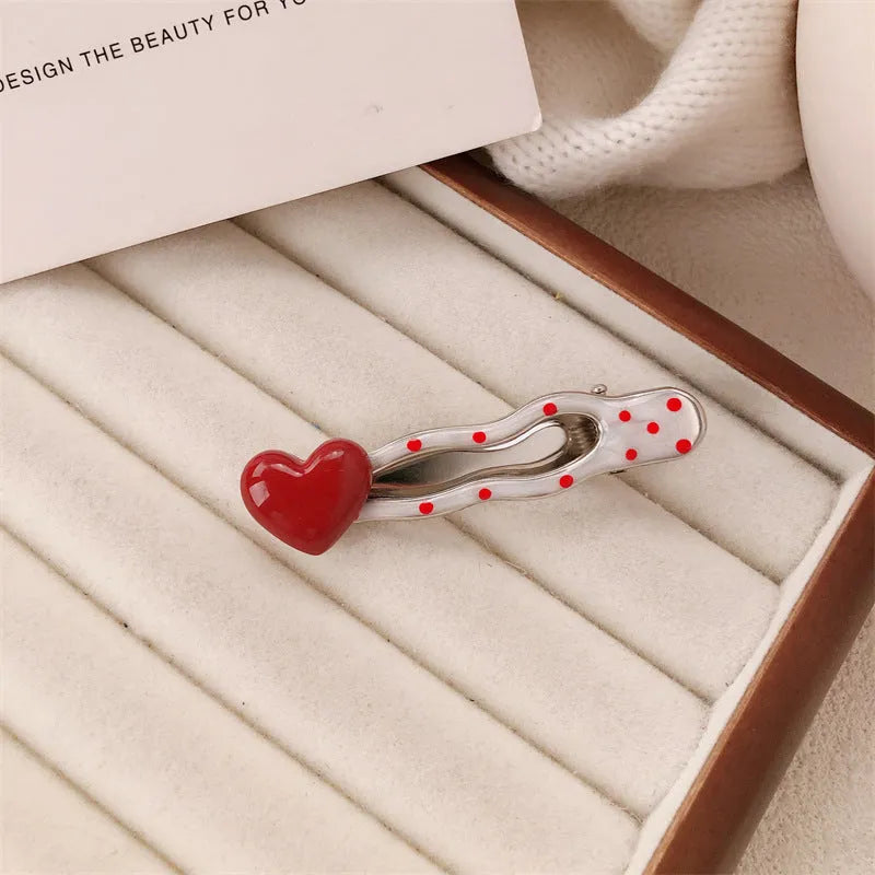 Red love heart-shaped hair barrette clip with retro white dots on a willow leaf-shaped base.