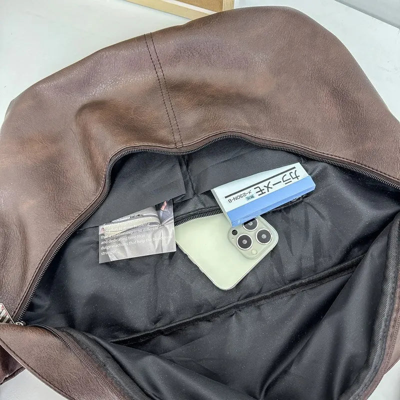Men's brown vintage PU leather crossbody bag showing large main compartment and slim profile