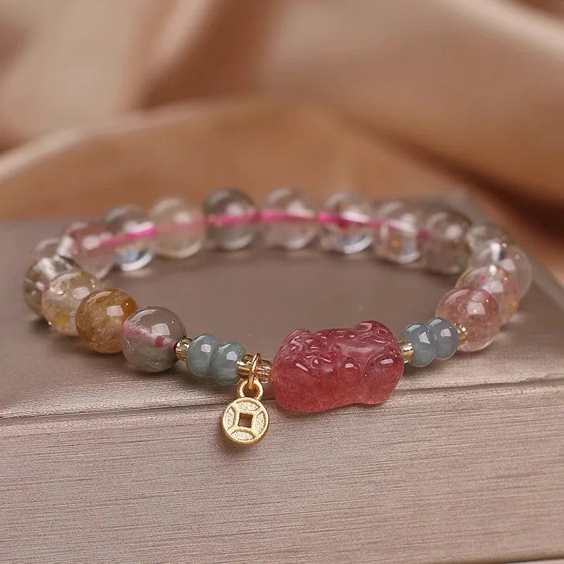 Colourful hair crystal stretch bracelet with cat's paw, butterfly, flower, and purse charms on adjustable band