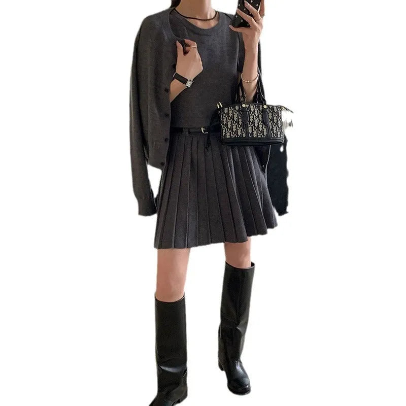 Women's grey knitted vest skirt and cardigan set with 3D pattern, adjustable belt, and pleating detail