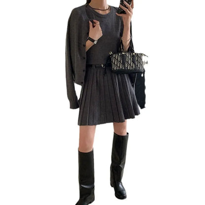 Women's grey knitted vest skirt and cardigan set with 3D pattern, adjustable belt, and pleating detail