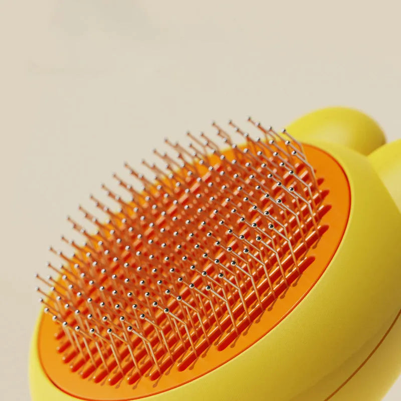 Green self-cleaning pet grooming brush with release button and stainless steel comb on a wooden table.