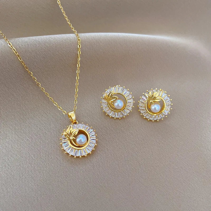 Women's geometric leaves design jewellery set with titanium steel necklace and gold plated stud earrings.