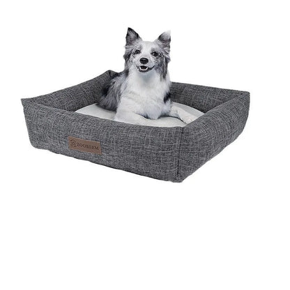 Grey linen-look square dog bed for medium-sized dogs on a wooden floor