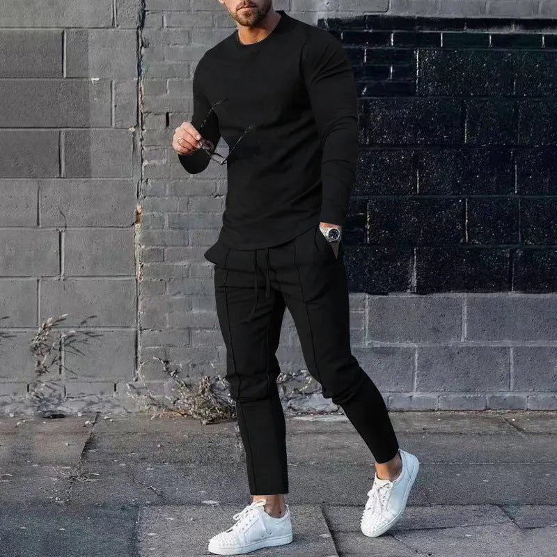 Men's solid colour two-piece lounge suit with long sleeve T-shirt and trousers in light grey.