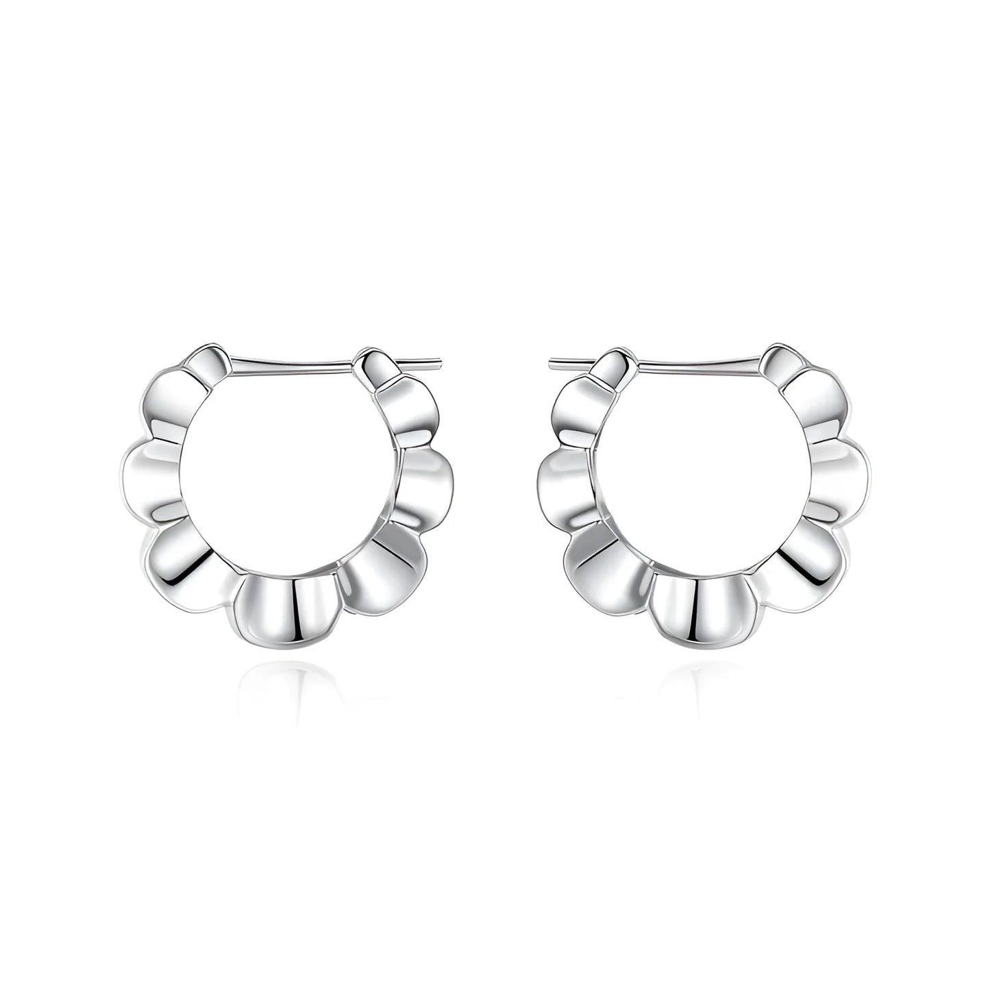 A pair of shiny silver geometric stud earrings with a round design on a plain background.