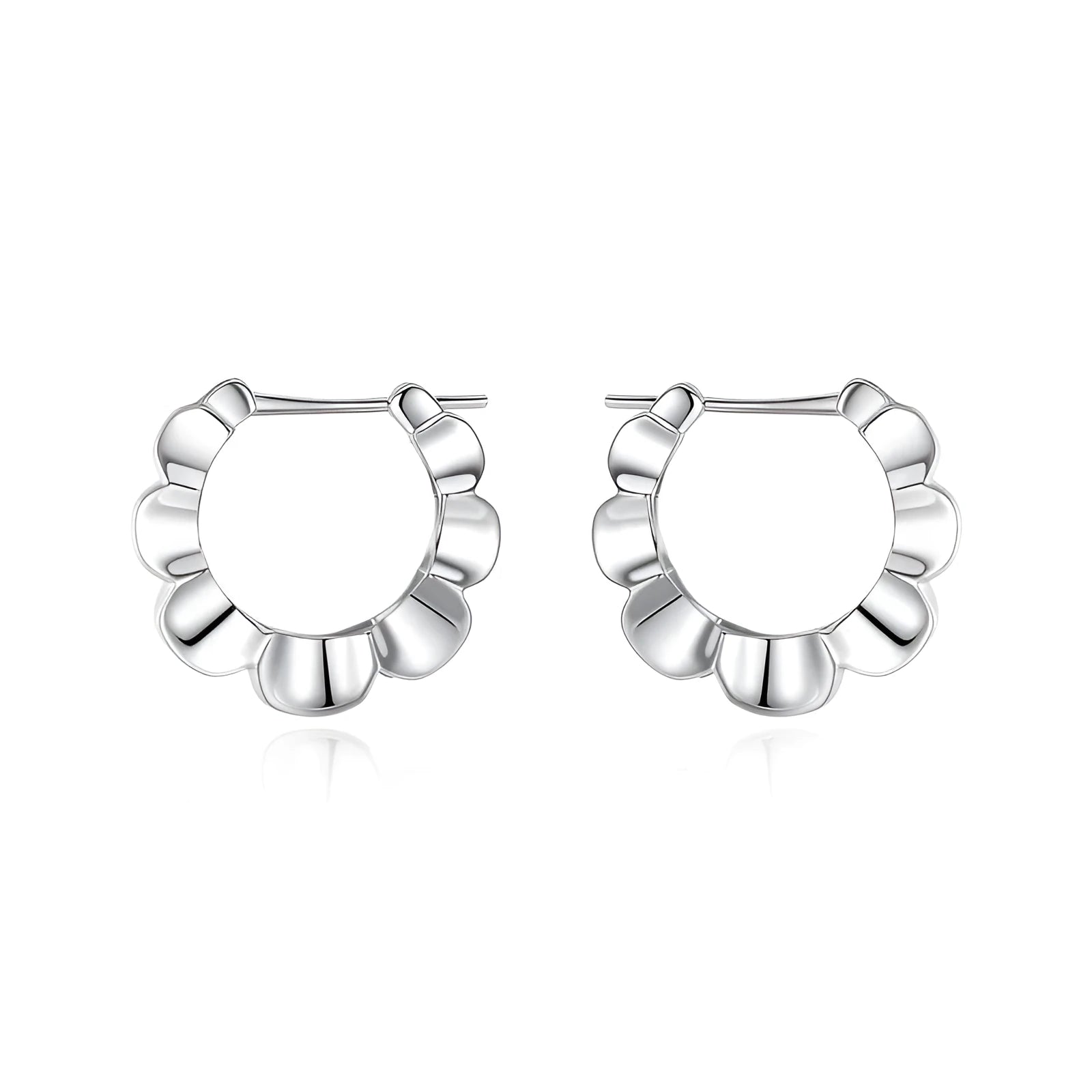 A pair of shiny silver geometric stud earrings with a round design on a plain background.