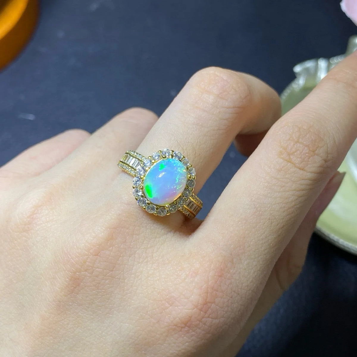 Handmade adjustable silver ring with a natural opal, shown in rose gold, yellow gold, and white gold plated finishes.