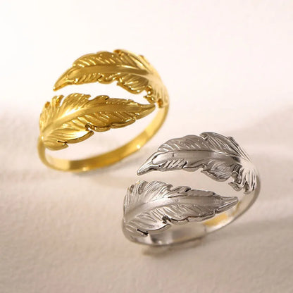 Women's stainless steel feather fashion ring with adjustable opening in silver or gold colour