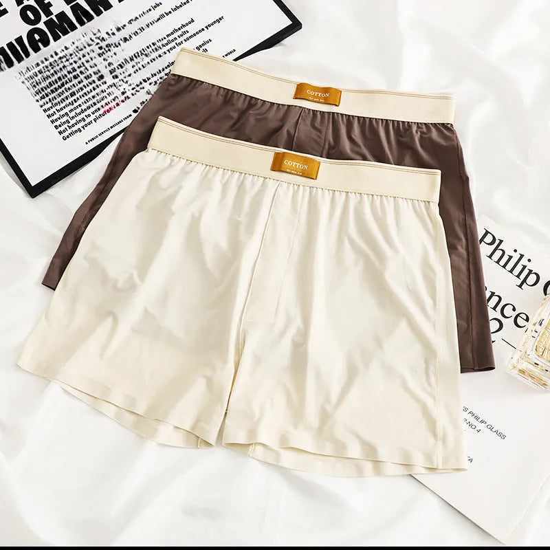 Pack of three pairs of solid colour men's ice silk briefs on a white background