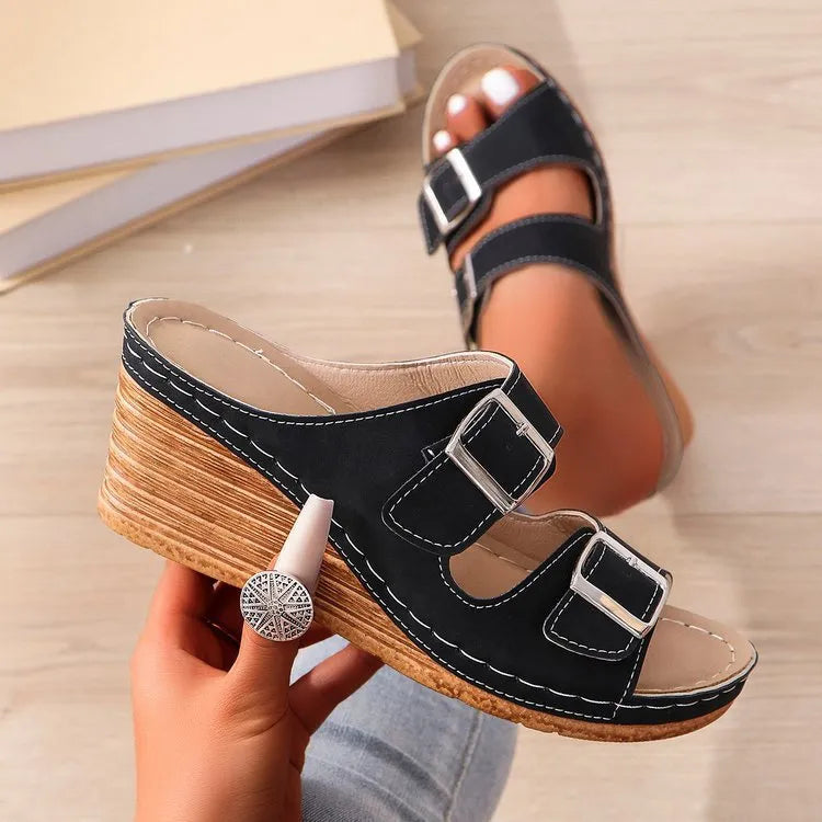 Women's creamy-white outer wedge beach slippers with a belt buckle detail on the strap.