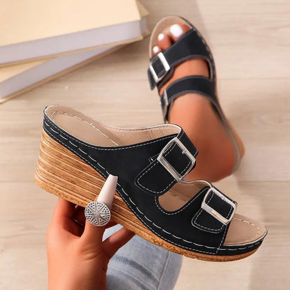 Women's creamy-white outer wedge beach slippers with a belt buckle detail on the strap.