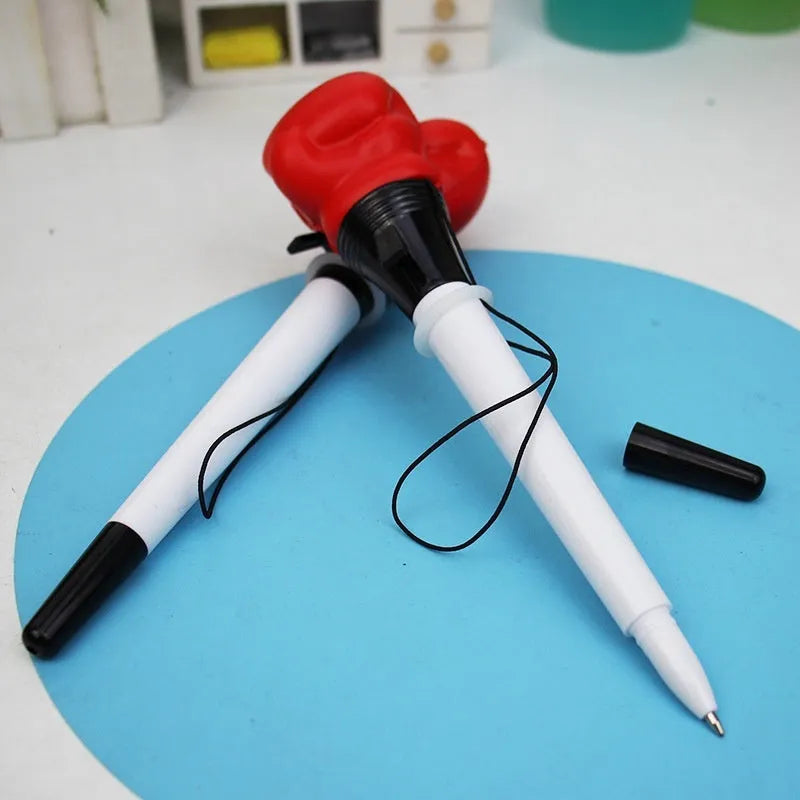 Creative Pressure Relief Stationery Boxing Press Ejection Pen: Plug-in sleeve design with bullet-shaped 0.7mm tip for precise writing and four black refills included for extended use.