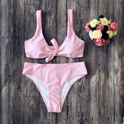 Solid colour bikini top and bottom in seamless polyester fabric on a neutral background.