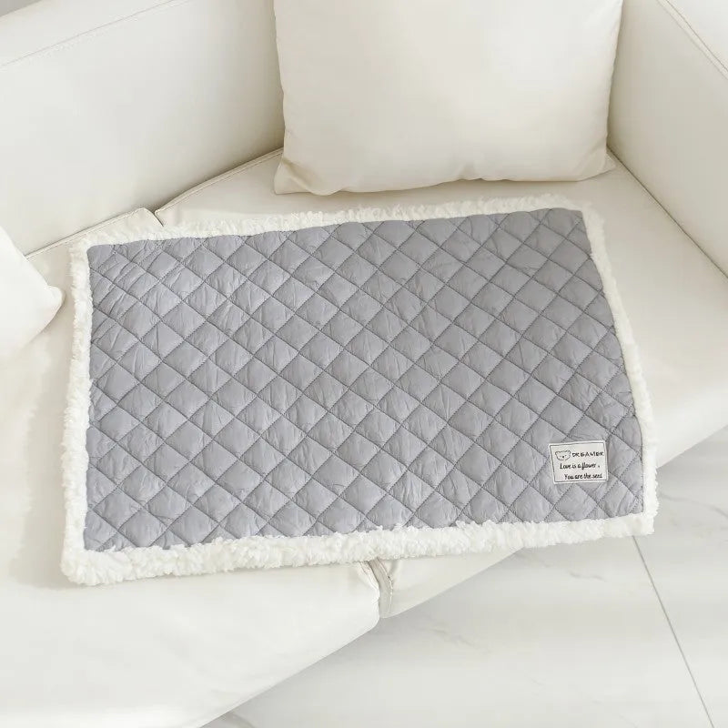 Blue quilted terry cloth pet blanket for cats shown in a cage, with size options M, L, and XL available.