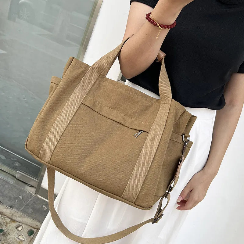 Large canvas tote bag in horizontal square shape with open-zip sides and internal organisers