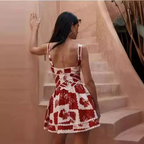 A beautiful red flower-patterned lace slip dress with a v-neck and waist cutout, perfect for summer fashion