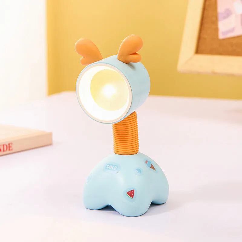 Colourful cartoon character magnetic DIY night light on a desk with adjustable head.