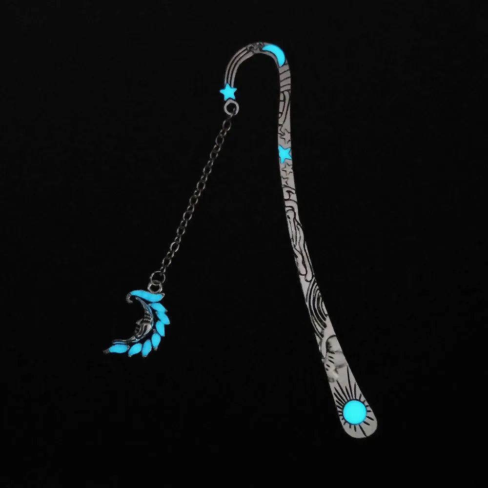 Retro five-pointed star glowing metal bookmark in ancient silver and bronze finishes on an open book.