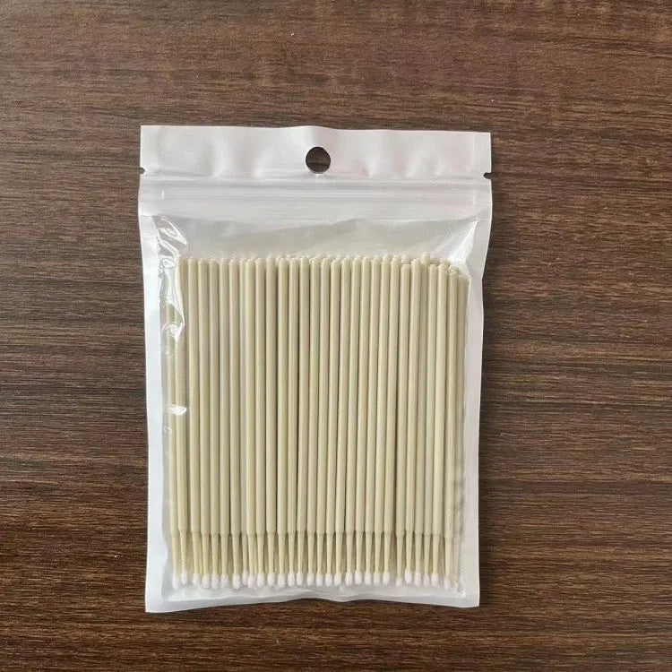 Disposable micro applicator brushes with coloured plastic handles and bendable cotton swab tips