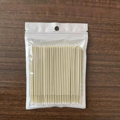 Disposable micro applicator brushes with coloured plastic handles and bendable cotton swab tips