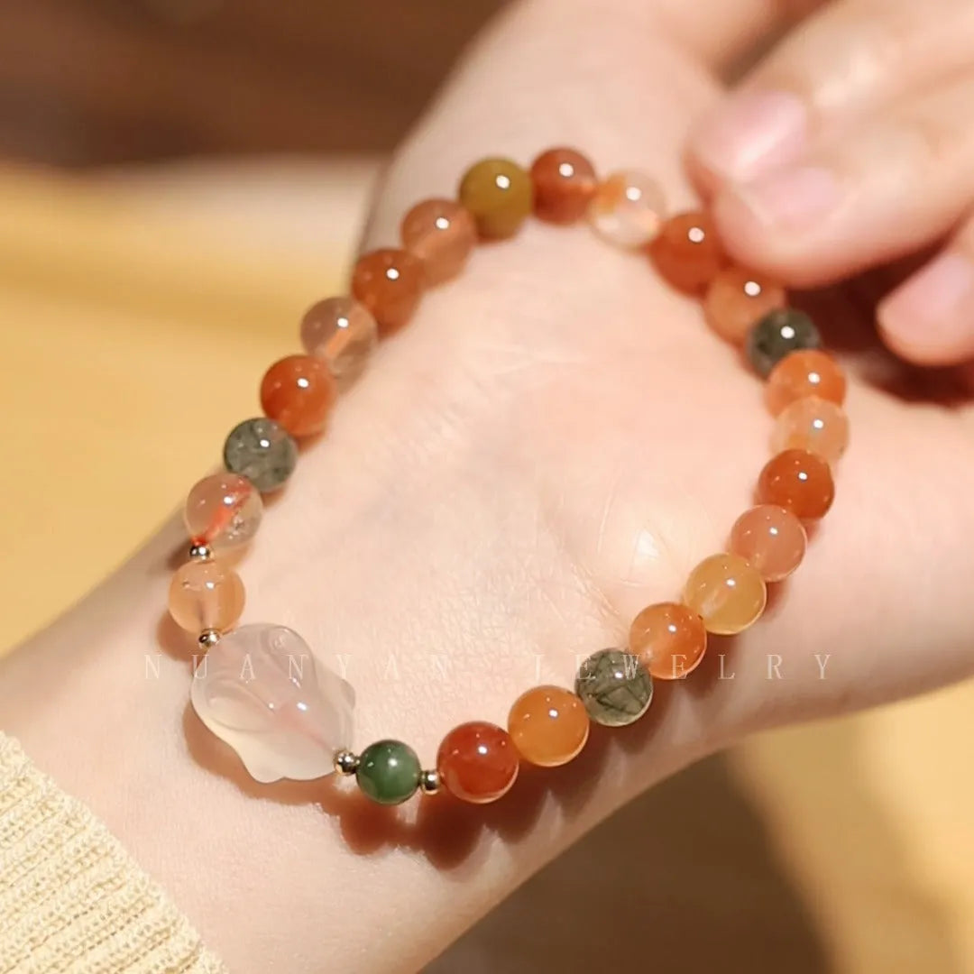 Handmade women's bracelet with a glass rabbit charm on a coloured glaze chain.