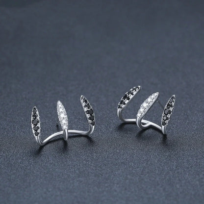 Elegant copper and zircon ear cuffs with a geometric design, showcasing British style and sophistication.