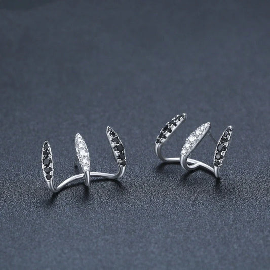 Elegant copper and zircon ear cuffs with a geometric design, showcasing British style and sophistication.