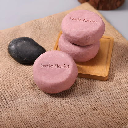 Pink round handmade rosewood grinding soap with roselle and tangerine peel ingredients