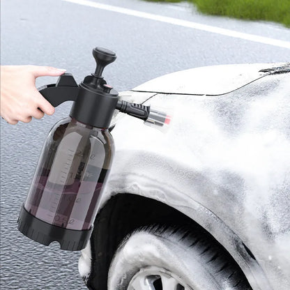 Black 2-litre hand-held foam sprayer with pump handle, shown with two nozzles for car washing and garden use.