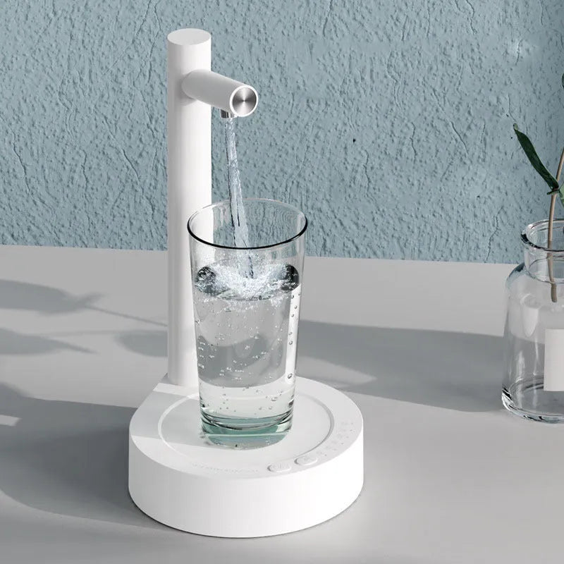 White electric water dispenser pump with USB cable for 5-gallon water bottles on desk