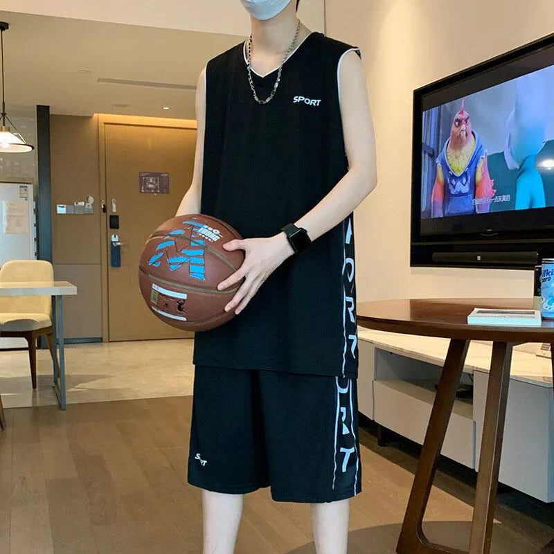 Man wearing a grey sleeveless basketball vest and matching shorts for sports.