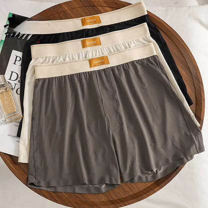 Pack of three pairs of solid colour men's ice silk briefs on a white background
