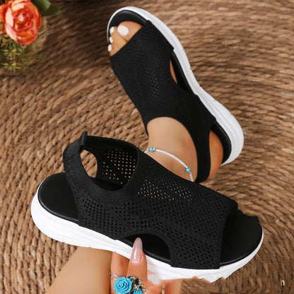 Women's black platform sports sandals with a flat toe and rubber sole on a light background
