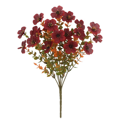 Artificial flower bouquet in autumn colours of red, yellow, and orange made from plastic and silk.
