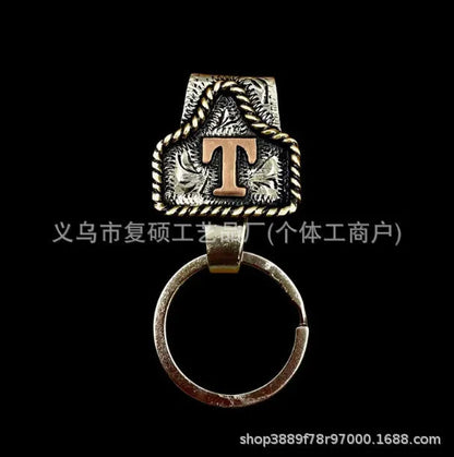 Handmade cow tag design metal keychain on a keyring, shown in one of many available colours.